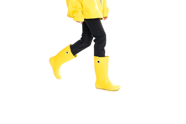 partial view of woman in yellow raincoat and rain boots isolated on white - Φωτογραφία, εικόνα