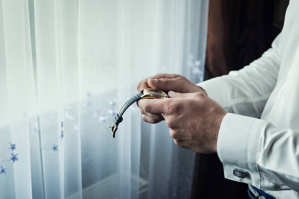 businessman checking time on his wrist watch, man putting clock on hand,groom getting ready in the morning before wedding ceremony - Photo, Image