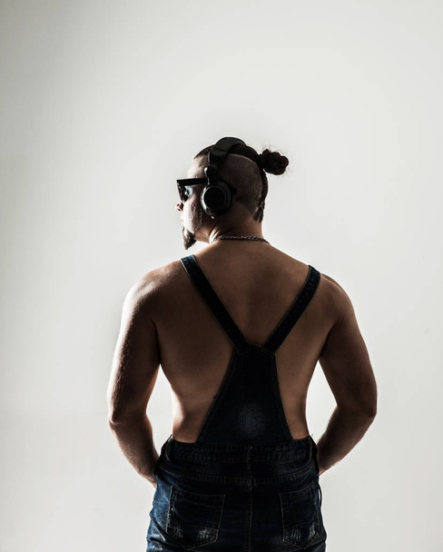 rear view - the rapper shirtless with headphones and stylish hai - Zdjęcie, obraz