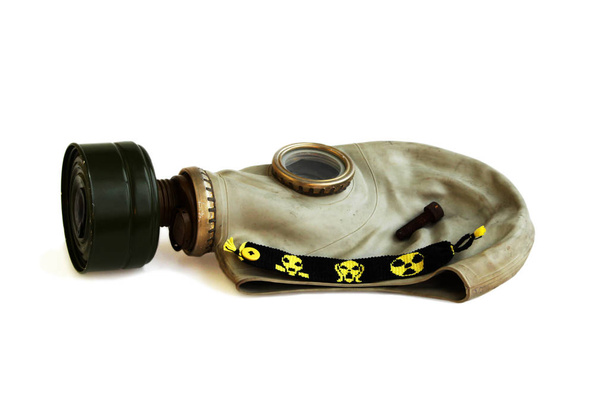 İzole kupa stalker: eski Rus gaz maskesi, paslı çivi ve beyaz zemin üzerine sarı-siyah baubles. - Fotoğraf, Görsel
