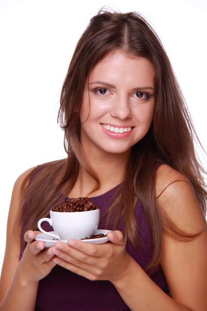 Young woman holding a cup of coffee beans - Foto, immagini