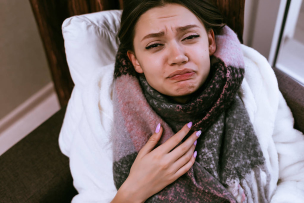 sad girl sick, neck warm scarf,sore throat and head - Zdjęcie, obraz