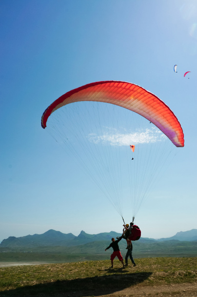 Two men parachuting on field with hills on backgrond, Crimea, Ukraine - Photo, Image