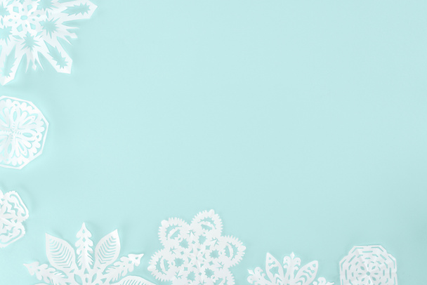 decorative christmas snowflakes, isolated on light blue with copy space - Photo, Image