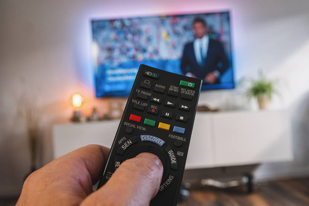 TV remote control, the hand with a remote control, pov view - Photo, Image