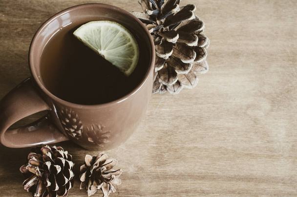 A cup of hot tea with lemon on a rustic table. - Φωτογραφία, εικόνα
