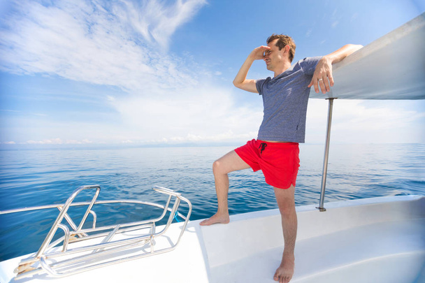 Mann auf weißem Luxusboot rast auf offenem Meer, Freiheit und aktives Lifestylekonzept - Foto, Bild