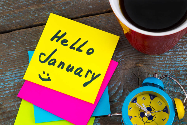 Hello January - handwriting in black ink on a sticky note with a - Foto, imagen