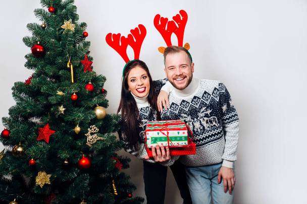 Christmas couple enjoying in the holidays and gifts - Zdjęcie, obraz