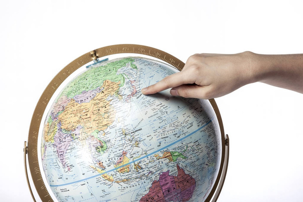 Pointing Hand on a globe. - Photo, Image