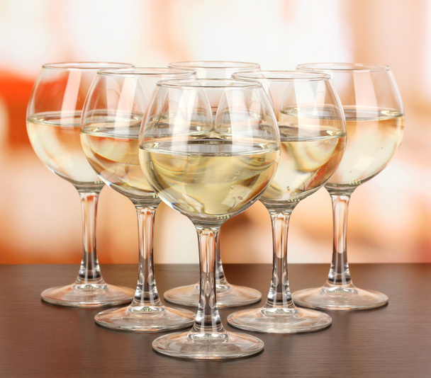 White wine in glass on room background - 写真・画像