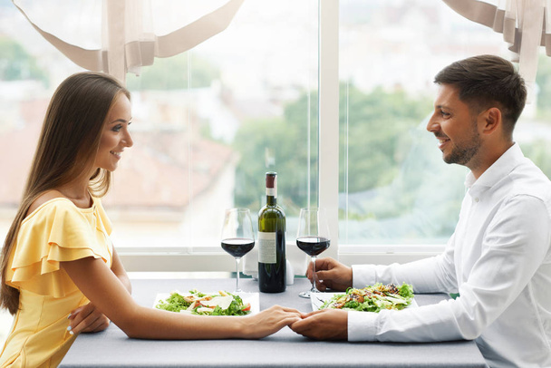 Romantic Couple Having Dinner For Two In Restaurant. - 写真・画像