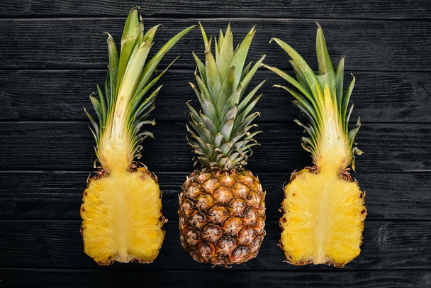 Pineapple on a wooden background. Top view. Free space for text. - Foto, Imagem