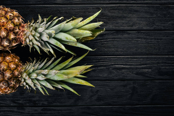 Pineapple on a wooden background. Top view. Free space for text. - Valokuva, kuva