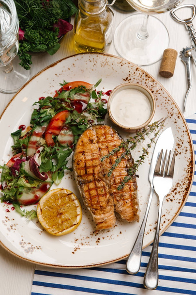 Жареный лосось с овощным салатом и белым соусом
 - Фото, изображение
