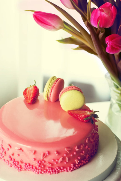 Delicious creamy cake with strawberies and macaroons on table cl - Photo, Image