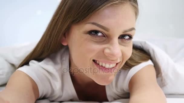 Beautiful Woman Lying in Bed Smiling and Looking in Camera - Footage, Video