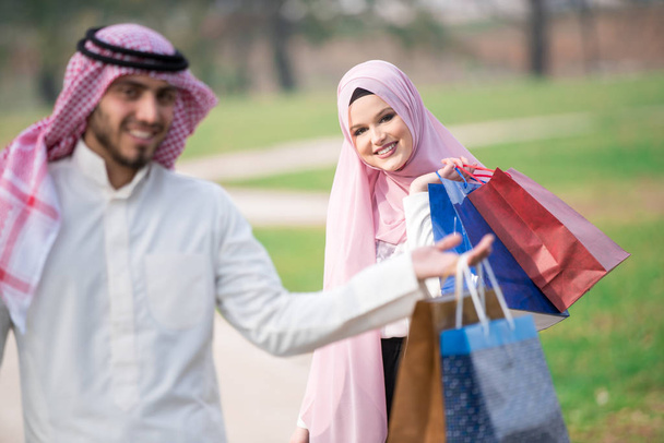 Lovely muslim couple taking a walk after shopping. concept - Foto, Imagen