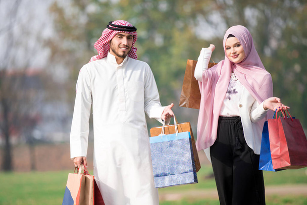Lovely muslim couple taking a walk after shopping. concept - Foto, afbeelding