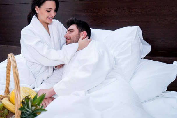 Couple relaxing in bed with fruit basket, pleasure - Фото, зображення