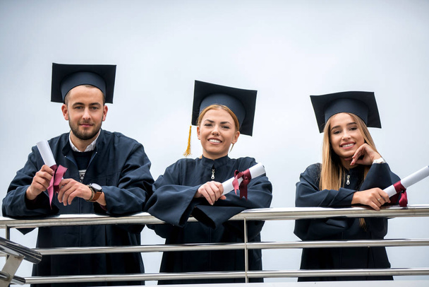 Group of Diverse International Graduating Students Celebrating, sitting and standing, concept - Φωτογραφία, εικόνα