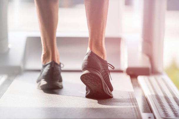 Young man in sportswear running on treadmill at gym - Φωτογραφία, εικόνα