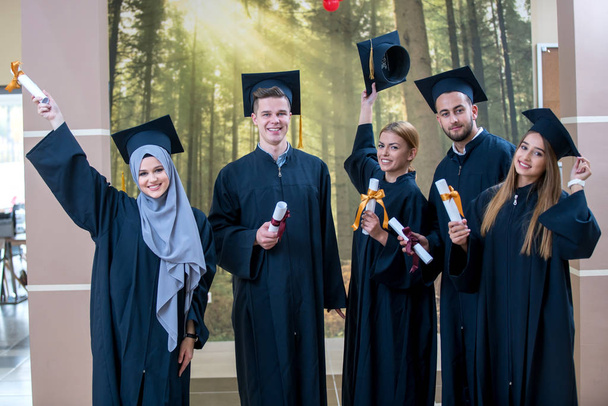 Group of Diverse International Graduating Students Celebrating, sitting and standing, concept - Zdjęcie, obraz