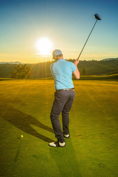 Man is playing golf during sunset - Photo, Image