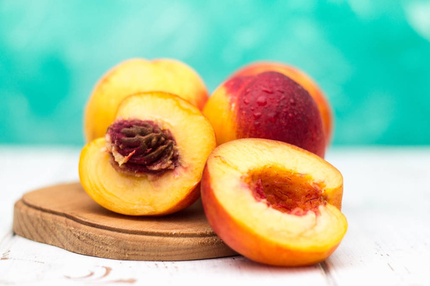 a lot of fresh peaches on a white table. - 写真・画像