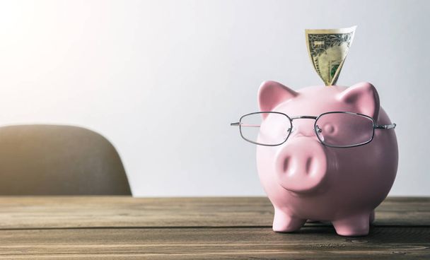 Piggy Bank con billete de dólar
 - Foto, imagen