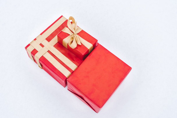 top view of red gift boxes with golden ribbons isolated on grey  - Fotó, kép