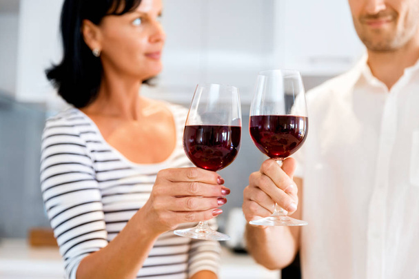 Portrait of a couple having a glass of red wine - Φωτογραφία, εικόνα