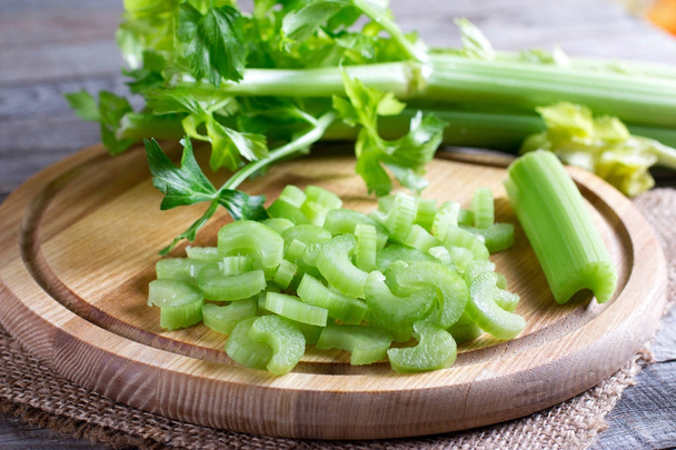 Fresh celery stalks on wooden chopping board - Photo, Image