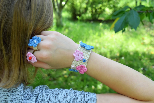 Crocheted your own jewelry. Pink and blue bracelet and ringlet on young girl. Step 3 - finished goods. DIY project. Small business. Income from hobby - Photo, Image