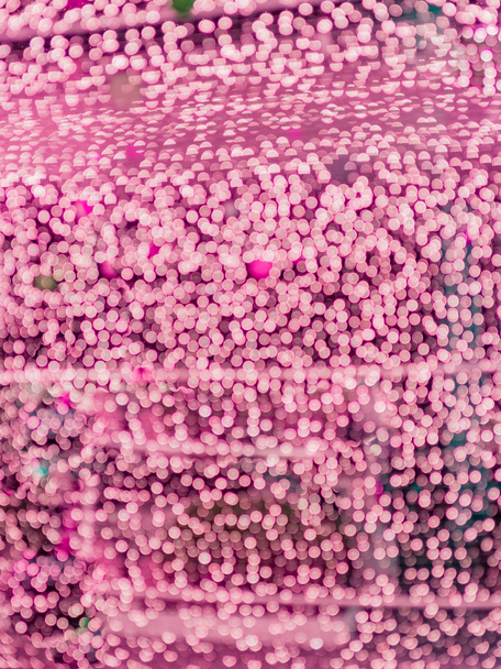 roze wazig bokeh licht intreepupil achtergrond en ribbels en noppen voor valaentine, Kerstmis, Nieuwjaar, feestdagen en viering achtergrond - Foto, afbeelding