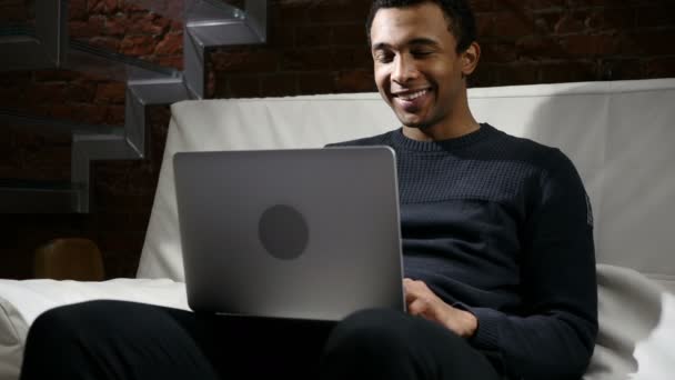 African Man Celebrating Success of Project, Working on Laptop - Materiał filmowy, wideo