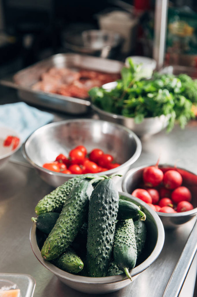 bowls with assorted fresh vegetables at restaurant kitchen - Foto, Imagen