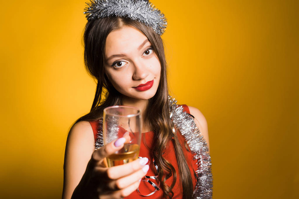 attractive girl in red dress celebrates the new year 2018, holds a glass of champagne in her hand - Photo, Image