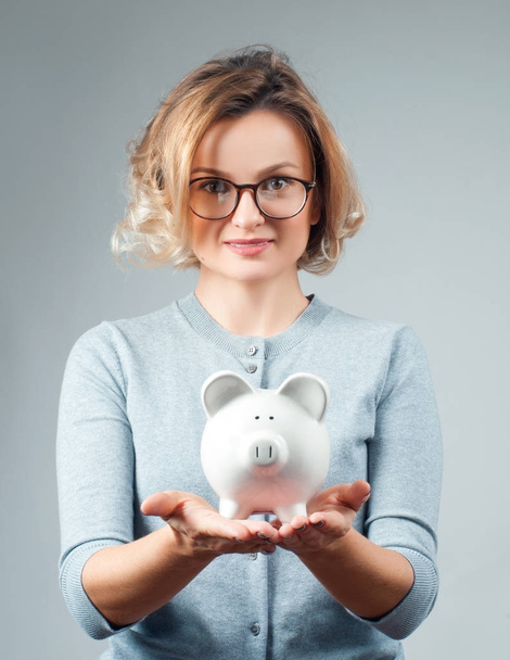 Savings concept. Woman holding piggy bank  - Fotoğraf, Görsel
