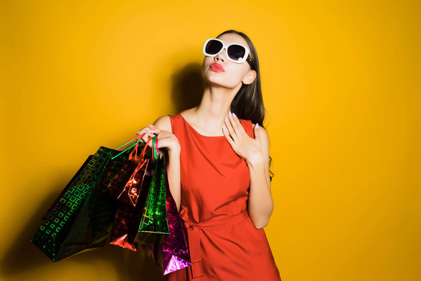 confident young girl shopaholic bought many gifts on a black Friday - Фото, изображение