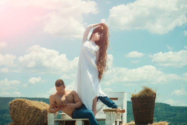 Man read book and woman touch long hair - 写真・画像