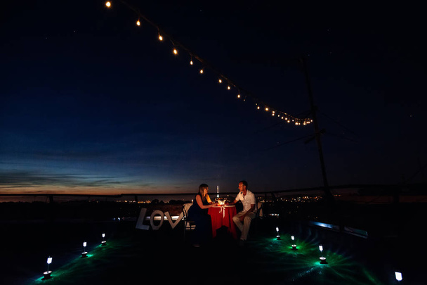 conversation between two lovers on a romantic date on the roof o - Photo, Image