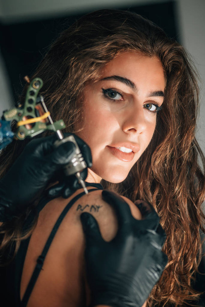 Linda chica haciéndose un tatuaje
 - Foto, Imagen