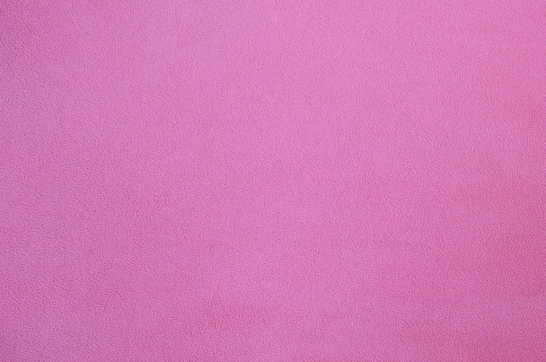 The blanket of furry pink fleece fabric. A background texture of light pink soft plush fleece material - Fotoğraf, Görsel