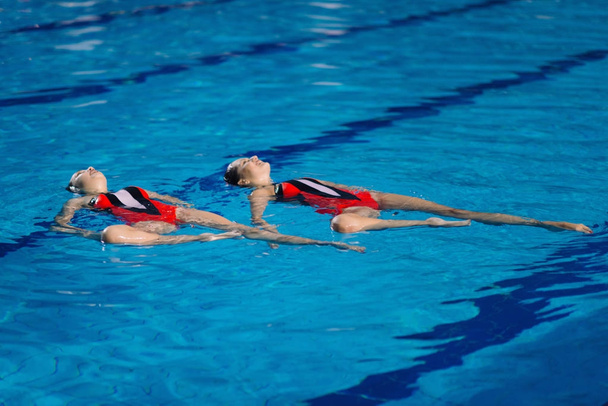 Synchronized Swimmers dancing on contest - Photo, Image