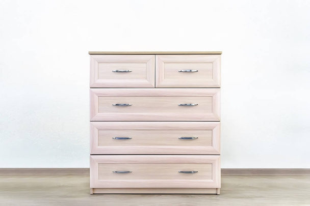 Women's chest of drawers with four drawers made of wood in a lady's bedroom - Photo, Image