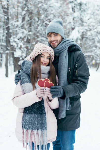 hellä pari punaisella sydämellä lumisessa puistossa talvipäivänä
 - Valokuva, kuva