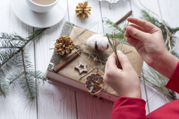 A cosy festive photo of a pair of childrens hands packing Christmas gifts  - Fotoğraf, Görsel