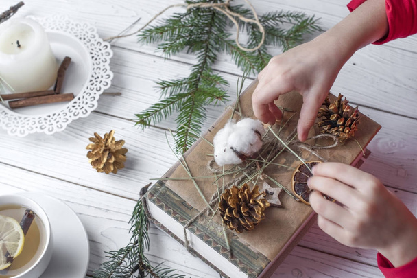 A cosy festive photo of a pair of childrens hands packing Christmas gifts  - Foto, immagini