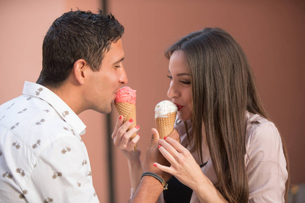 Cheerful couple eating ice cream cones - Fotoğraf, Görsel